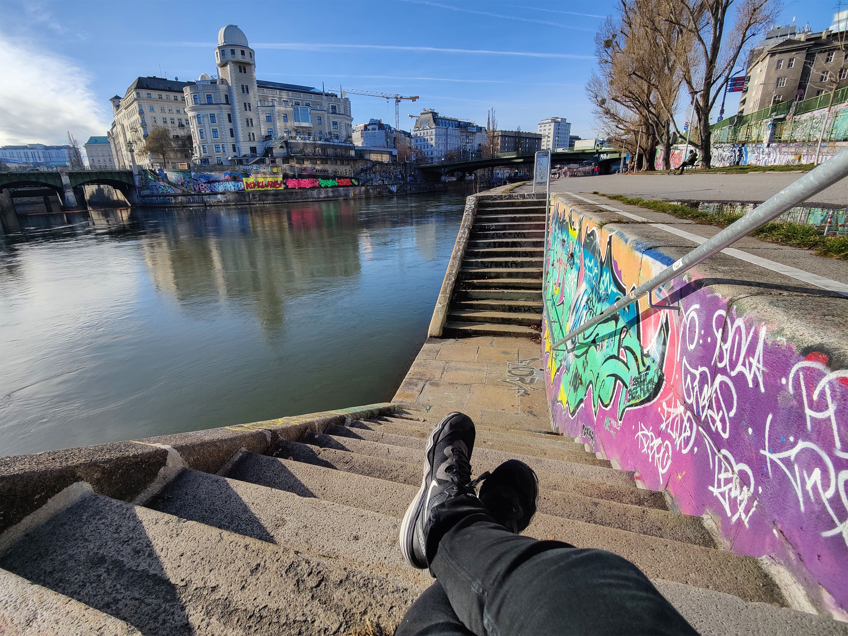 Sitting by the Danube Canal in Vienna, Austria